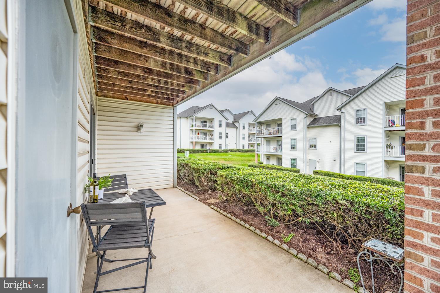 2011 Rudy Serra Drive, Unit 1C Eldersburg, MD 21784 - Photo 28 of 36 a front view of a house with a garden and plants