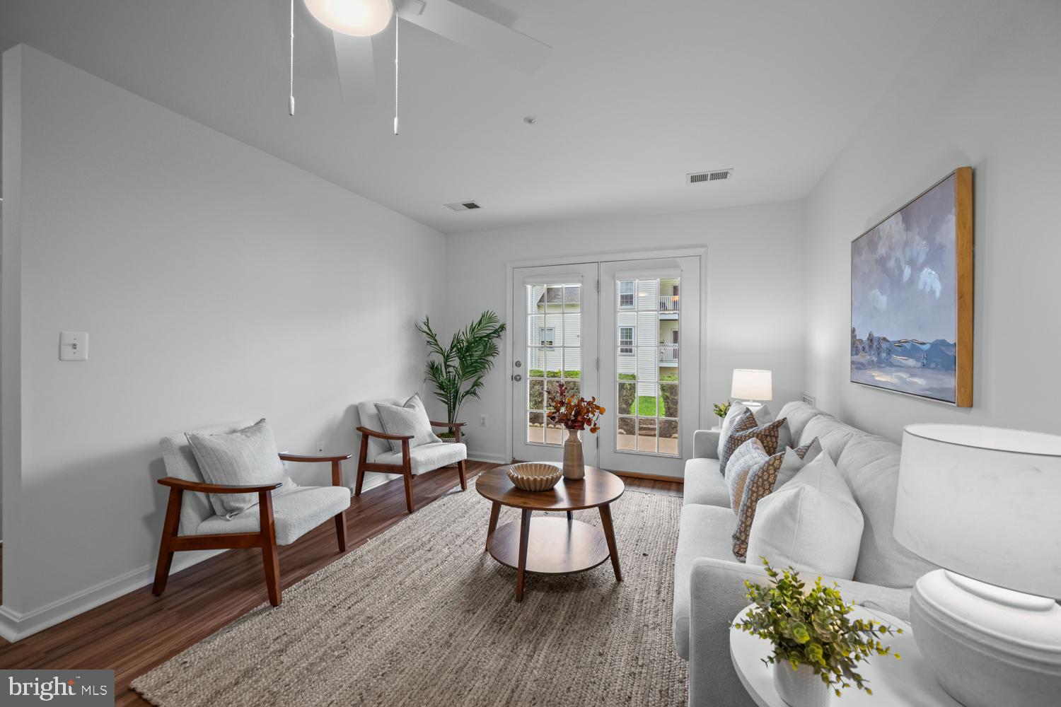 2011 Rudy Serra Drive, Unit 1C Eldersburg, MD 21784 - Photo 7 of 36 a living room with furniture and a wooden floor