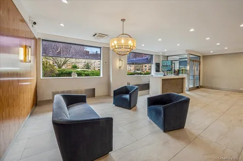 a living room with furniture a rug and a chandelier