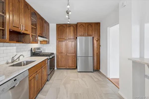 a kitchen with a sink refrigerator and cabinets
