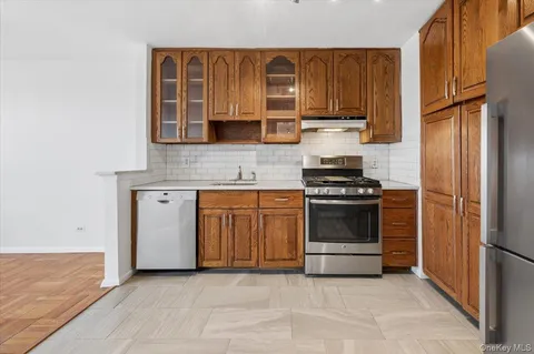 a kitchen with granite countertop a stove and a refrigerator