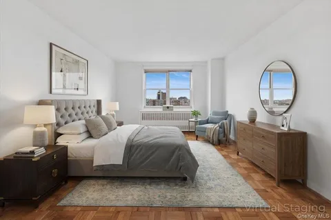 a bedroom with a large bed and a chandelier