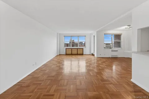 a view of empty room with a kitchen