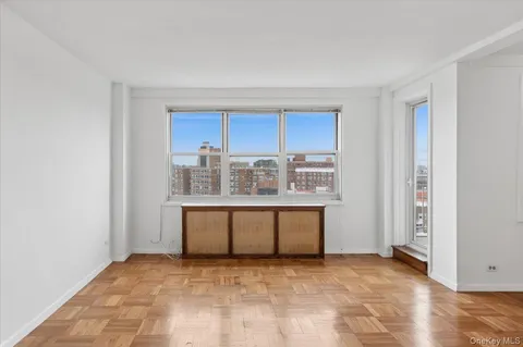 a view of kitchen with stainless steel appliances granite countertop cabinets and window