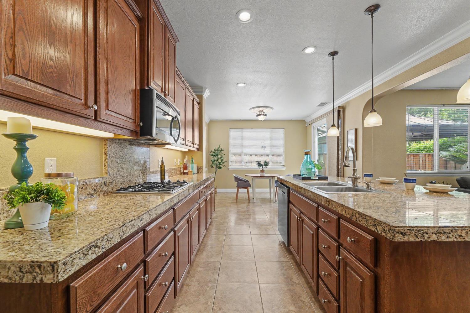 1223 East Springer Drive Turlock, CA 95382 - Photo 17 of 48 a kitchen with sink stove and cabinets