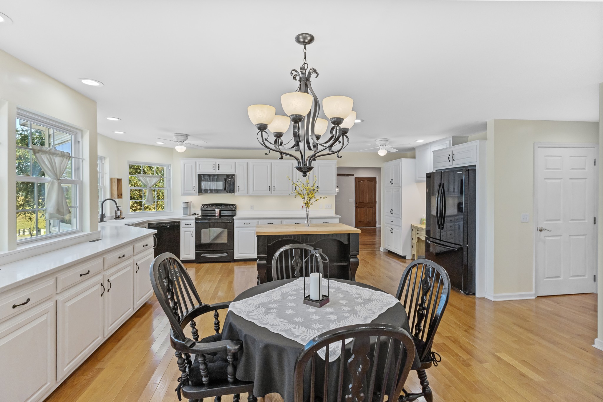 2960 Canoe Branch Road Lebanon, TN 37087 - Photo 31 of 80 a view of a dining room with furniture a chandelier and wooden floor