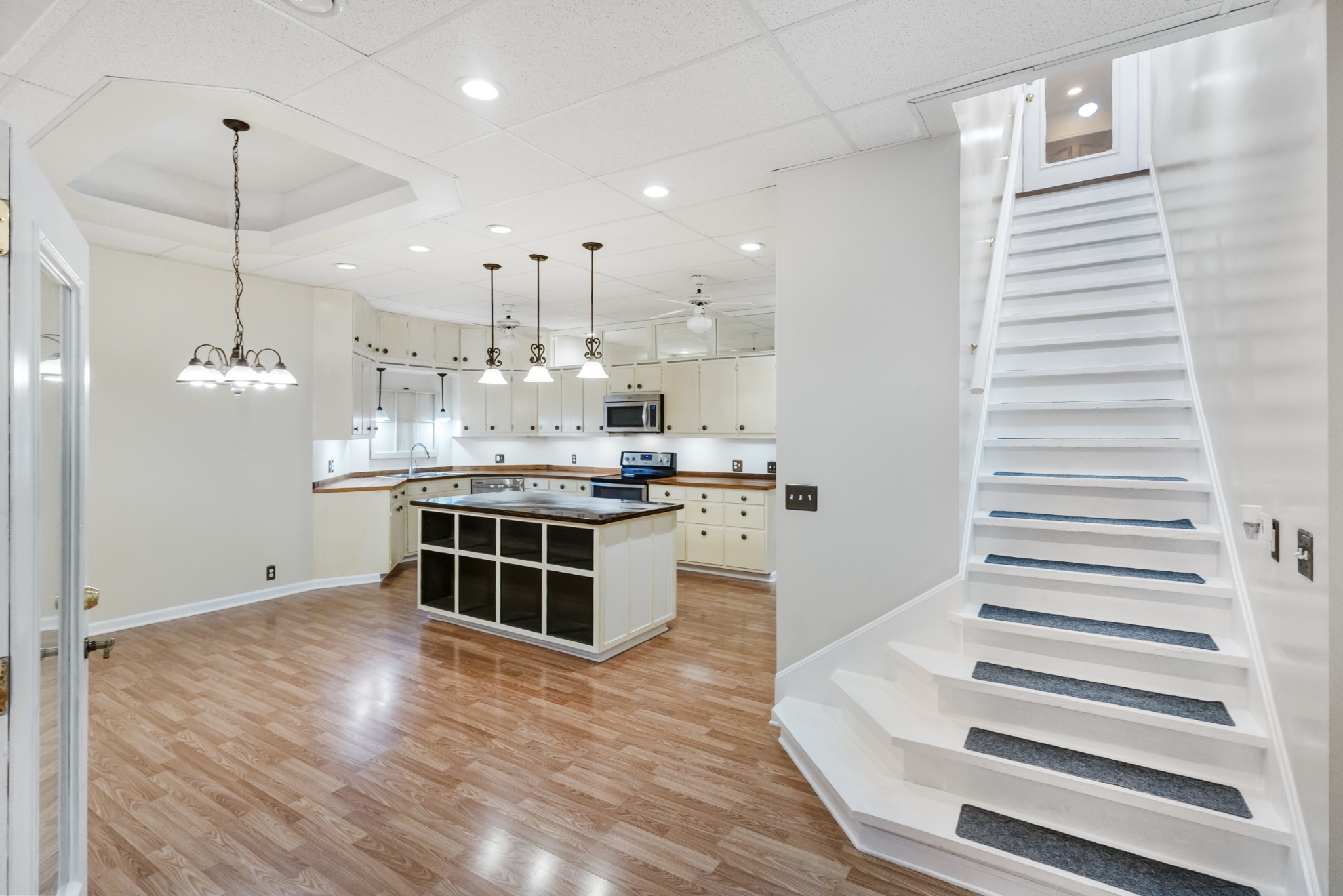 2960 Canoe Branch Road Lebanon, TN 37087 - Photo 66 of 80 a kitchen with kitchen island stainless steel appliances a large counter top and wooden floor