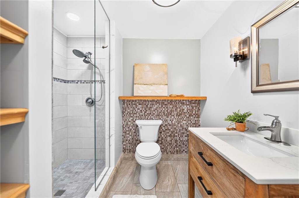 505 Blue Ridge Drive Coraopolis, PA 15108 - Photo 36 of 49 Full bathroom in basement with beautiful mosaic tile accent wall, and tiled shower.