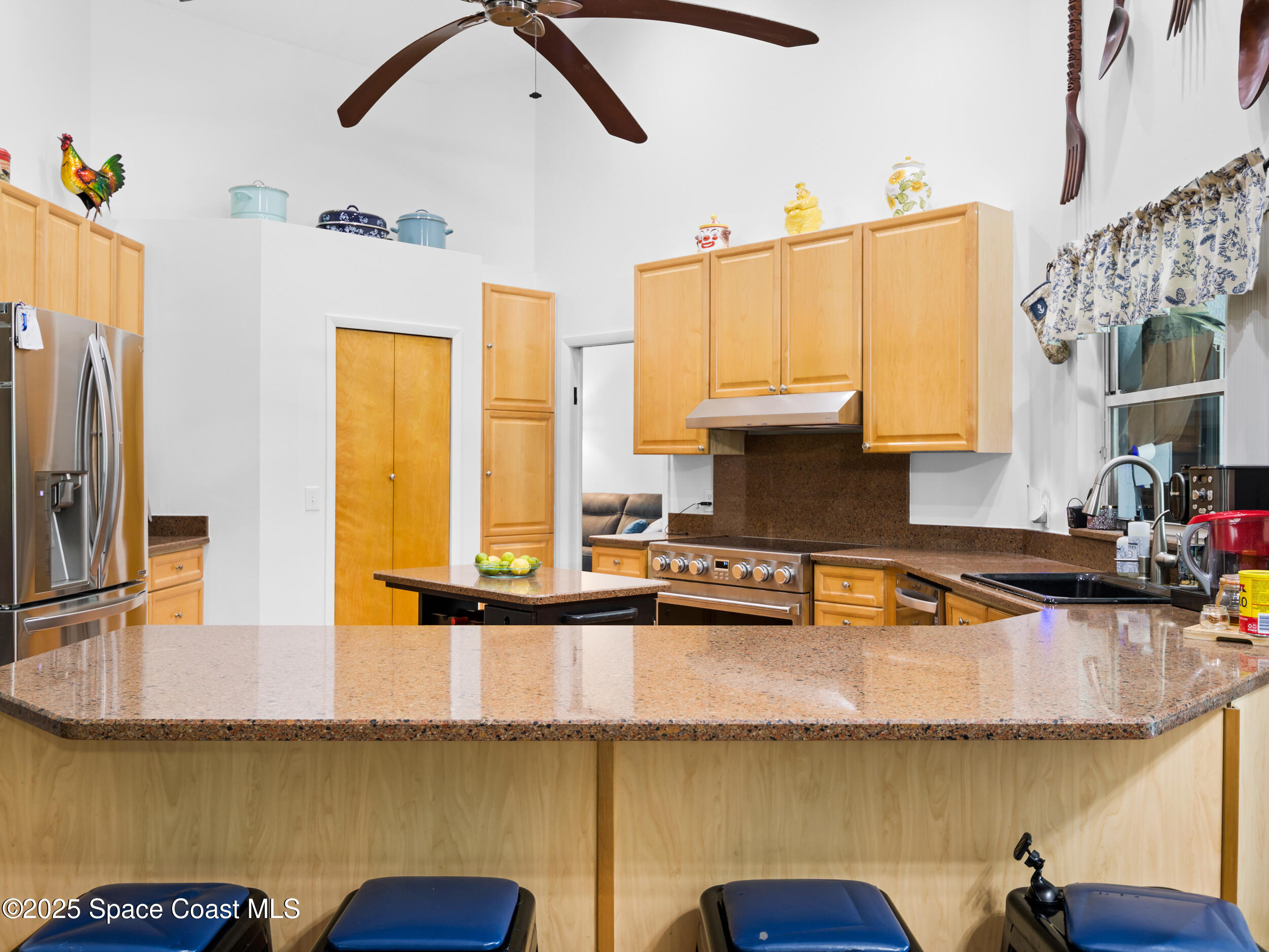 239 Deer Run Road Palm Bay, FL 32909 - Photo 12 of 43 a kitchen with stainless steel appliances granite countertop a sink a stove and a refrigerator