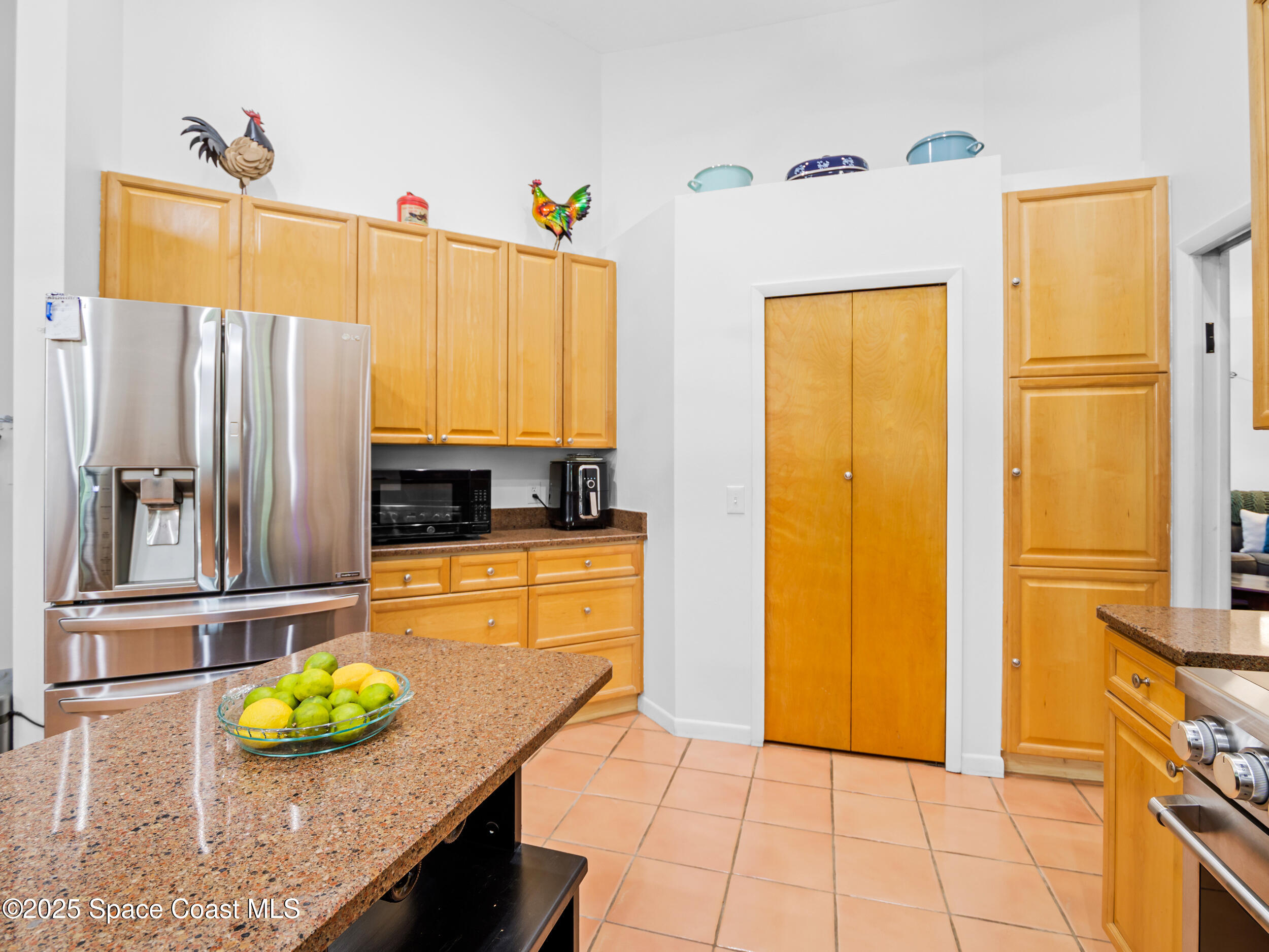 239 Deer Run Road Palm Bay, FL 32909 - Photo 14 of 43 a kitchen with stainless steel appliances granite countertop a refrigerator and a stove