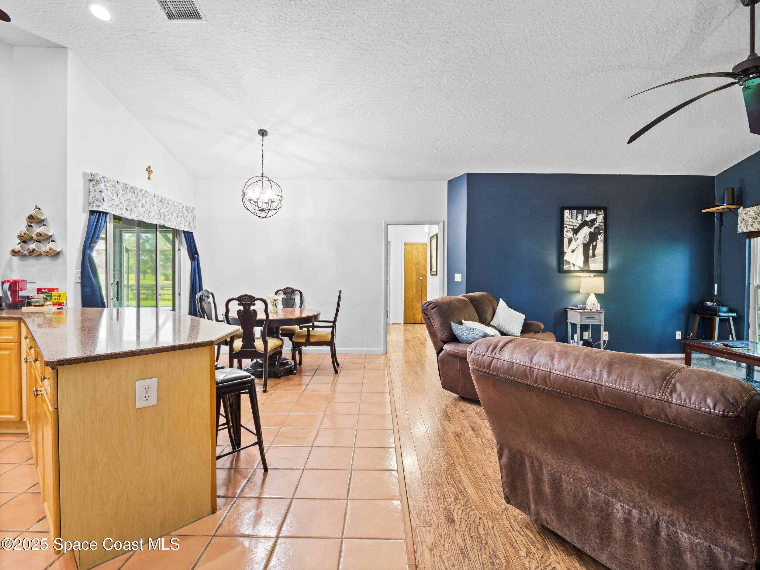 239 Deer Run Road Palm Bay, FL 32909 - Photo 16 of 43 a living room with furniture and a flat screen tv
