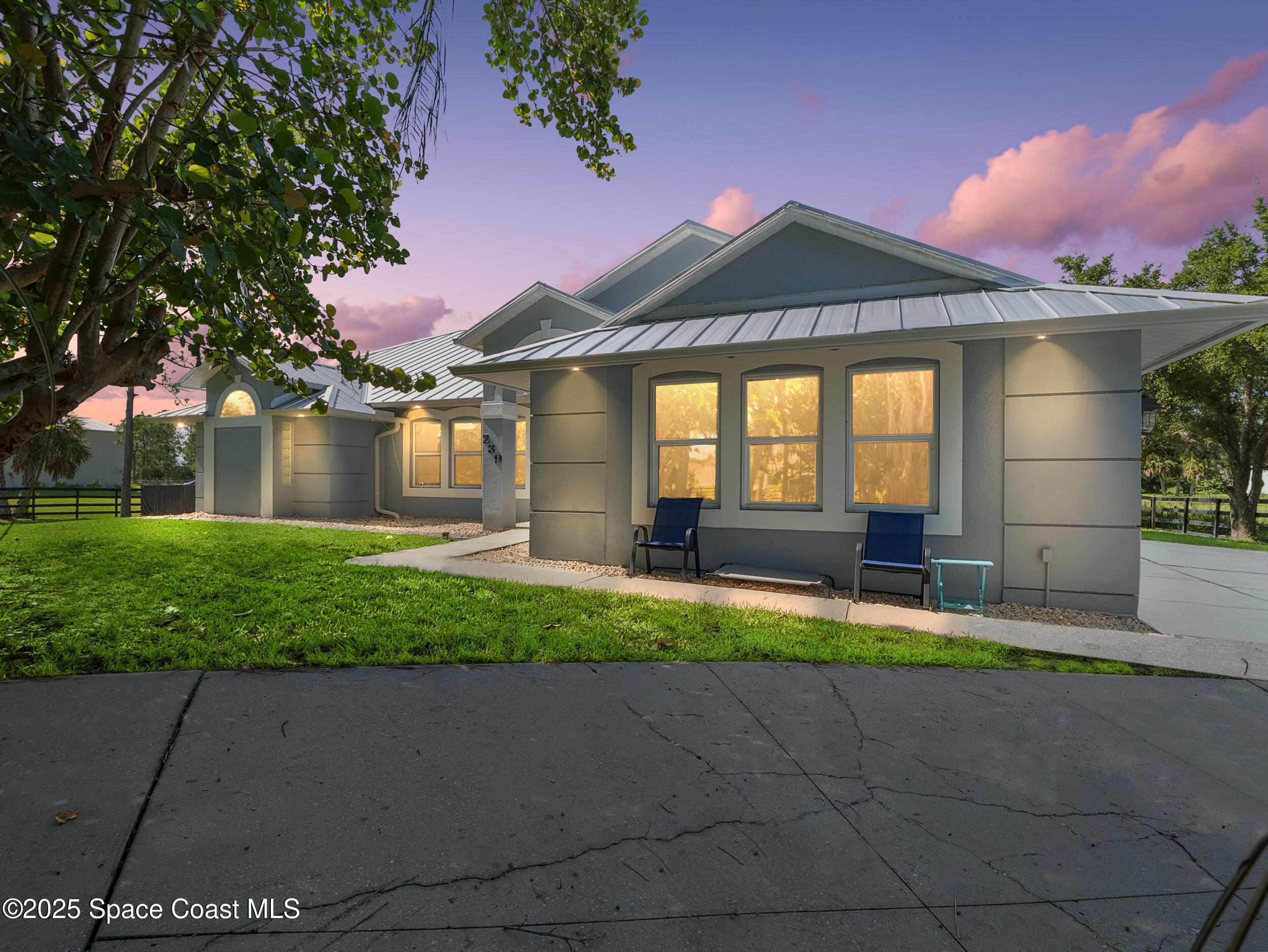 239 Deer Run Road Palm Bay, FL 32909 - Photo 2 of 43 a front view of a house with a yard and garage