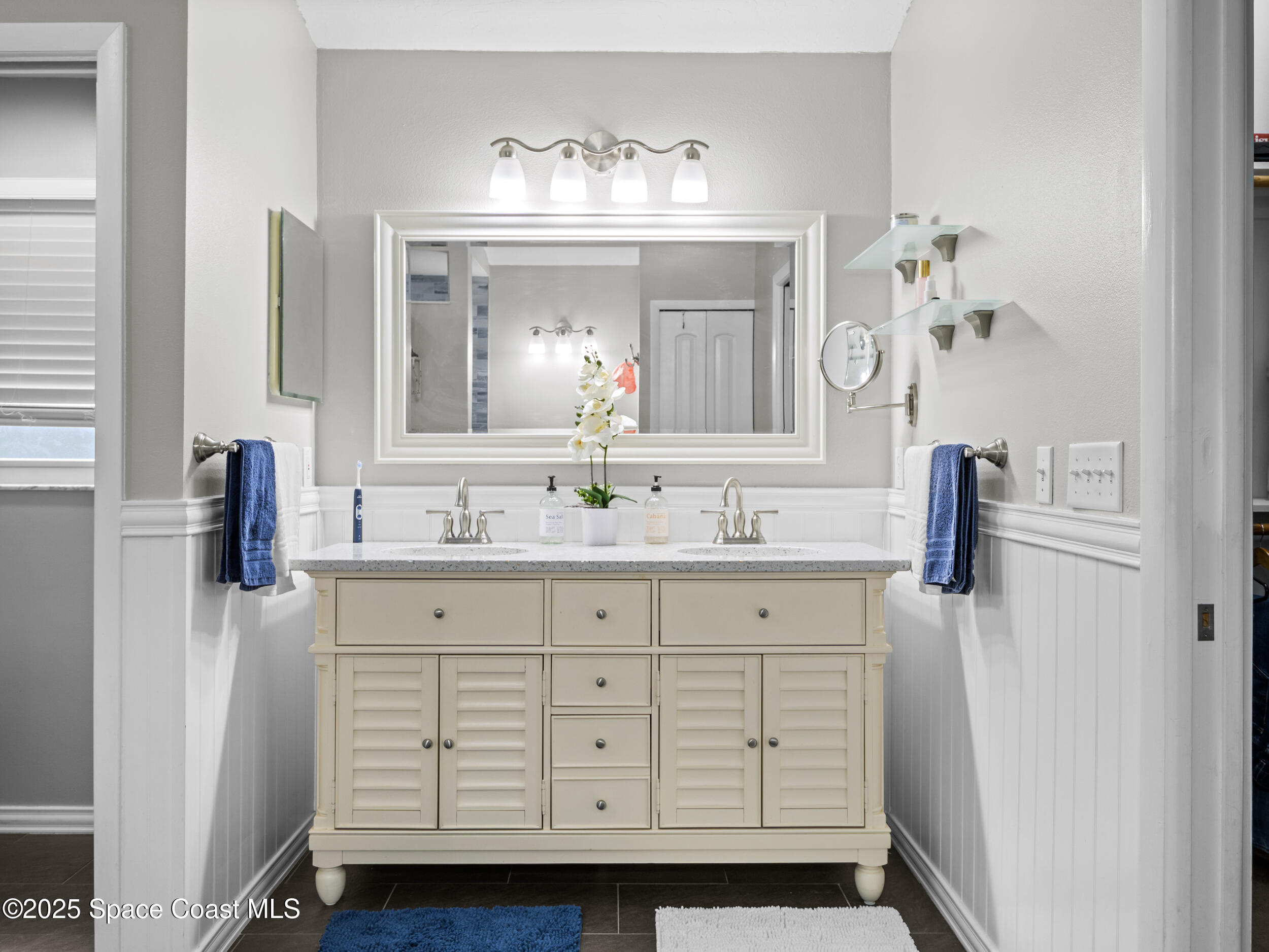 239 Deer Run Road Palm Bay, FL 32909 - Photo 23 of 43 a bathroom with a sink vanity and mirror