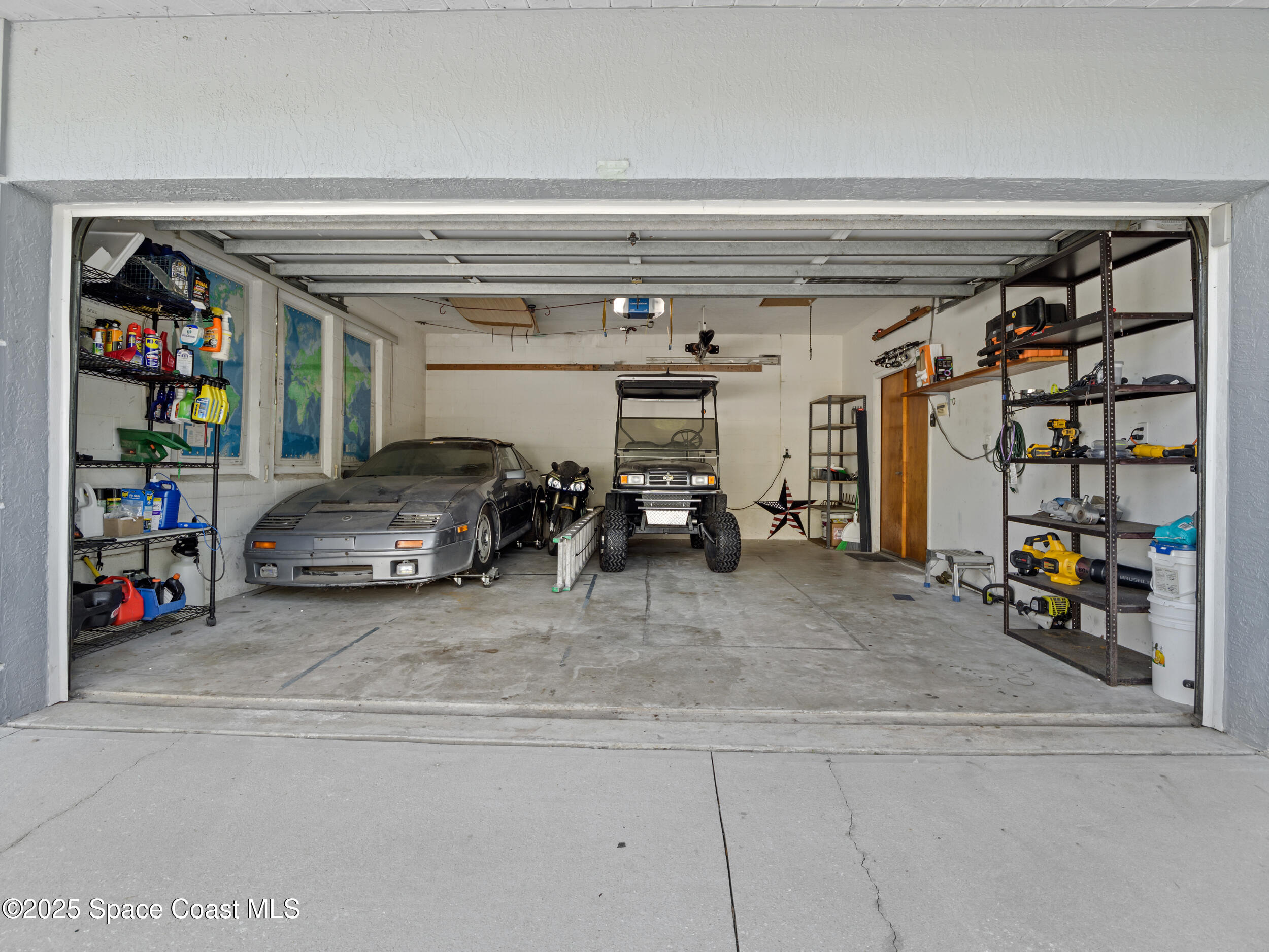239 Deer Run Road Palm Bay, FL 32909 - Photo 31 of 43 a view of parking garage with cars