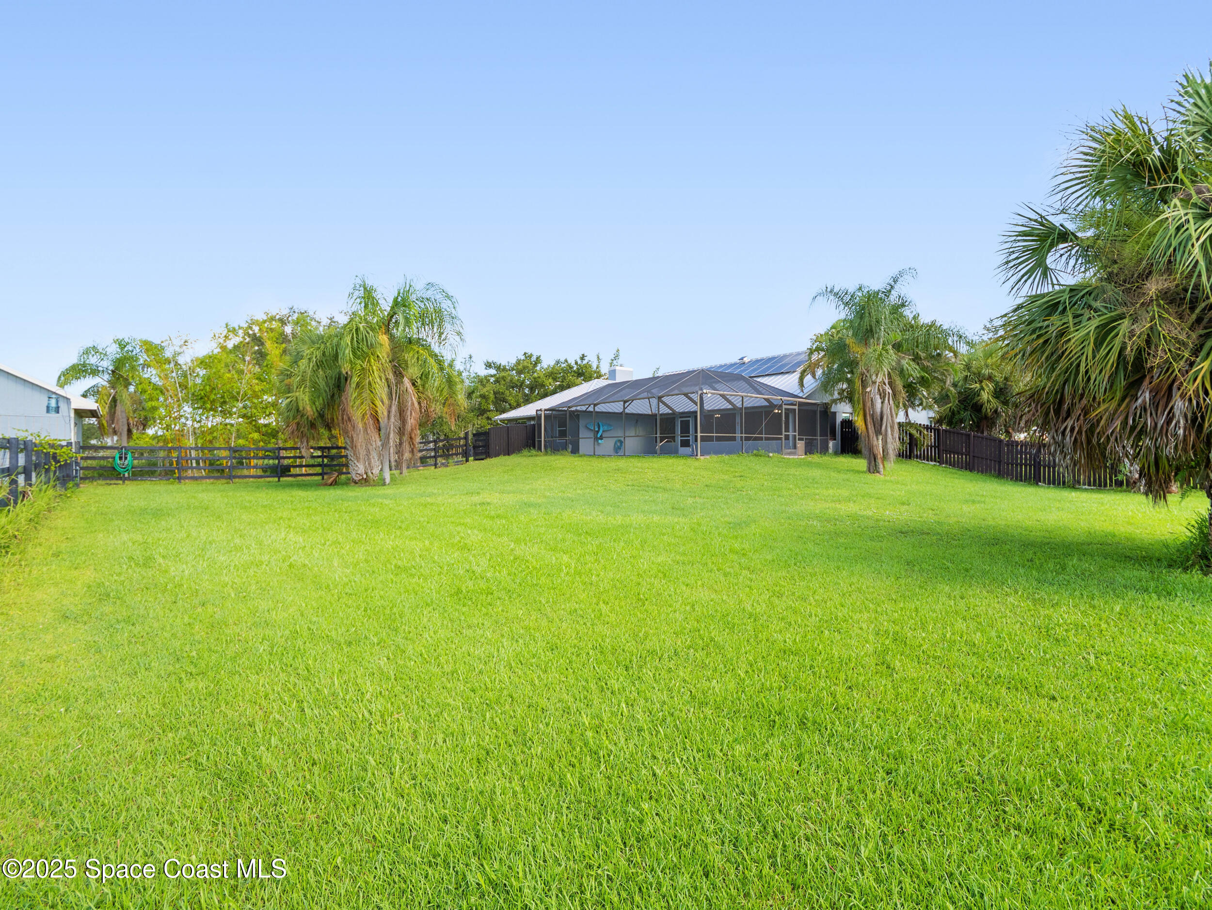 239 Deer Run Road Palm Bay, FL 32909 - Photo 32 of 43 a view of a garden with a building in the background