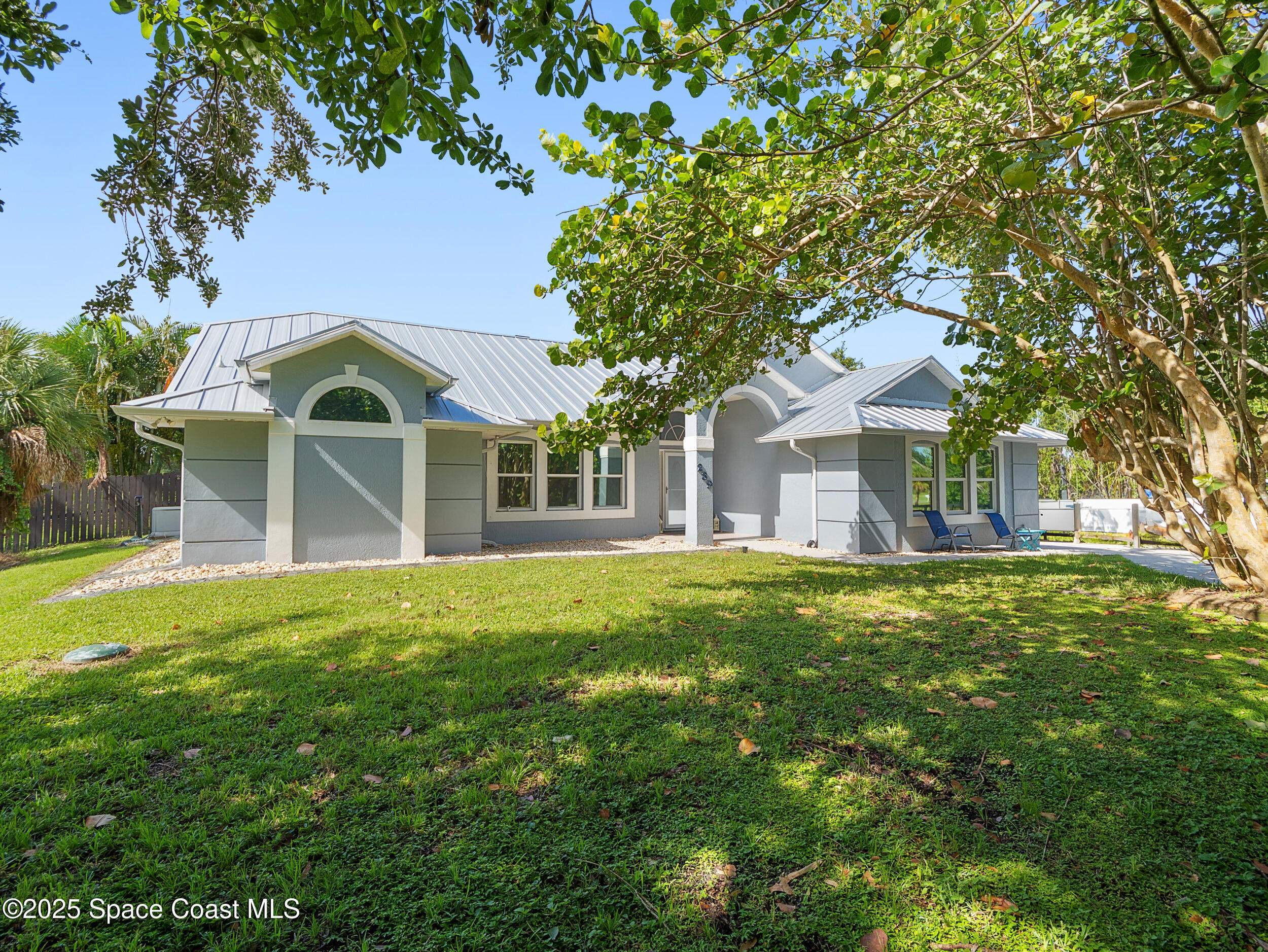 239 Deer Run Road Palm Bay, FL 32909 - Photo 33 of 43 a front view of a house with a garden