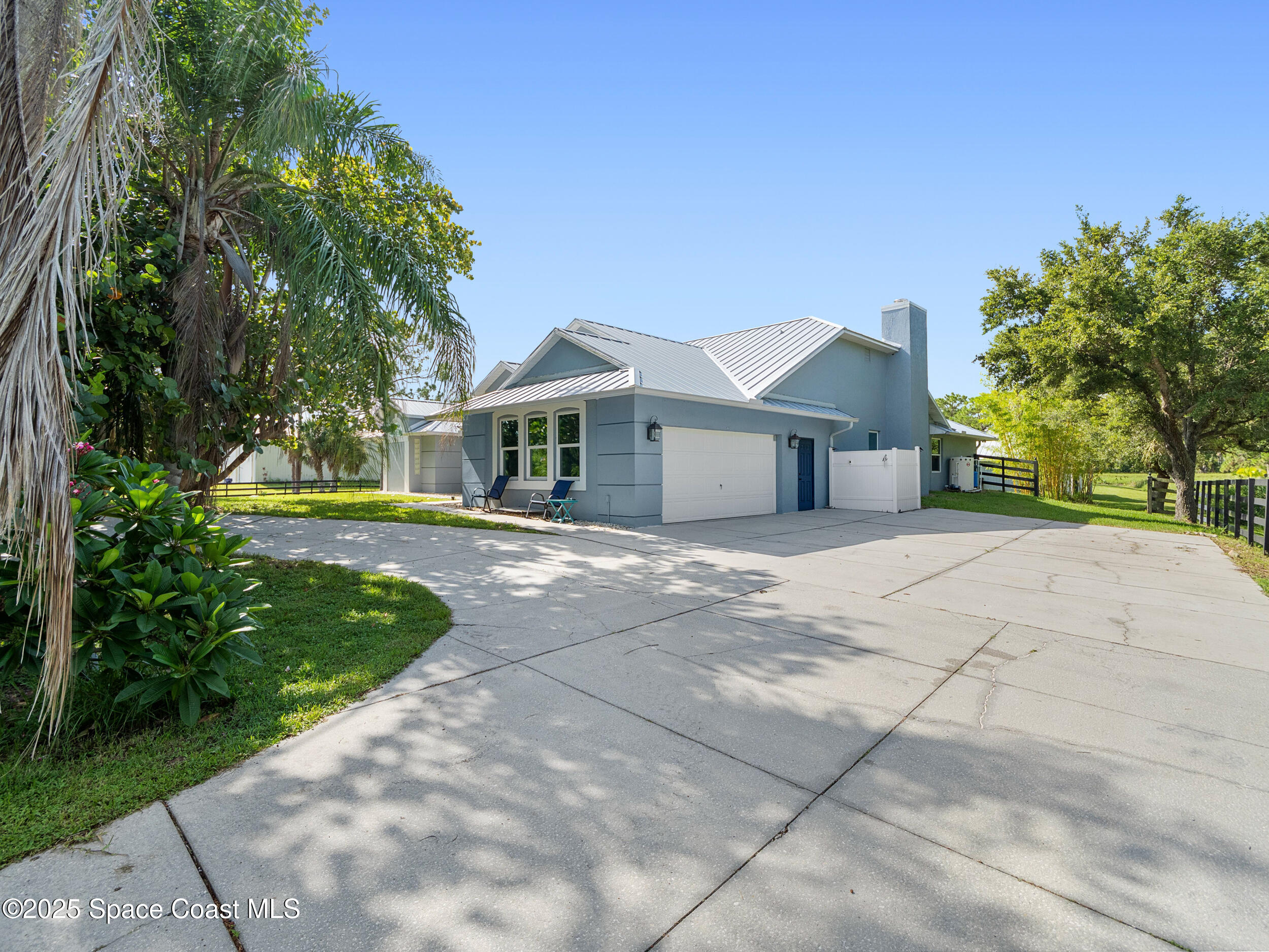 239 Deer Run Road Palm Bay, FL 32909 - Photo 34 of 43 a front view of a house with a yard