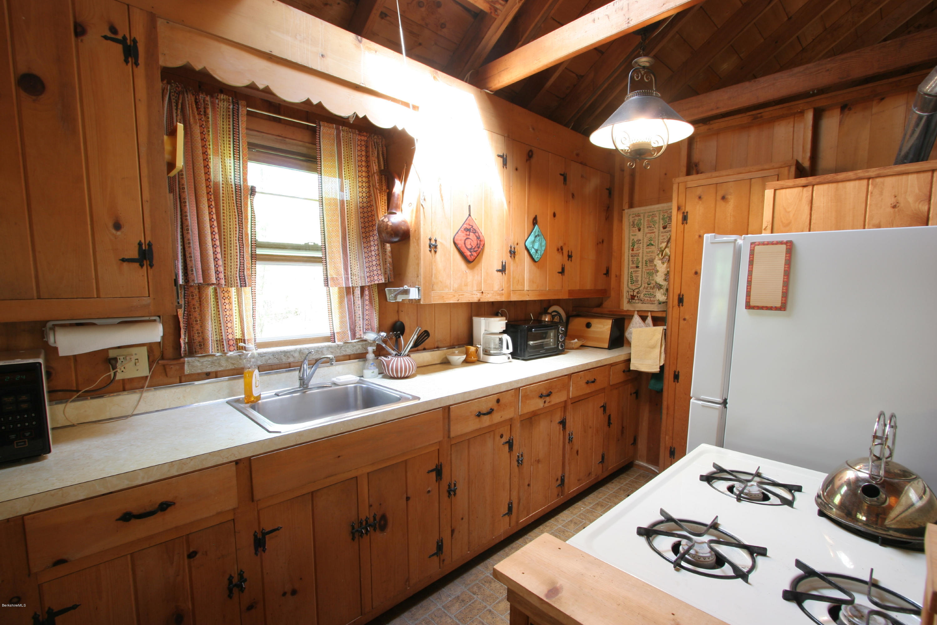 22 Housatonnuck Road Stockbridge, MA 01262 - Photo 14 of 21 a kitchen with a sink stove and cabinets