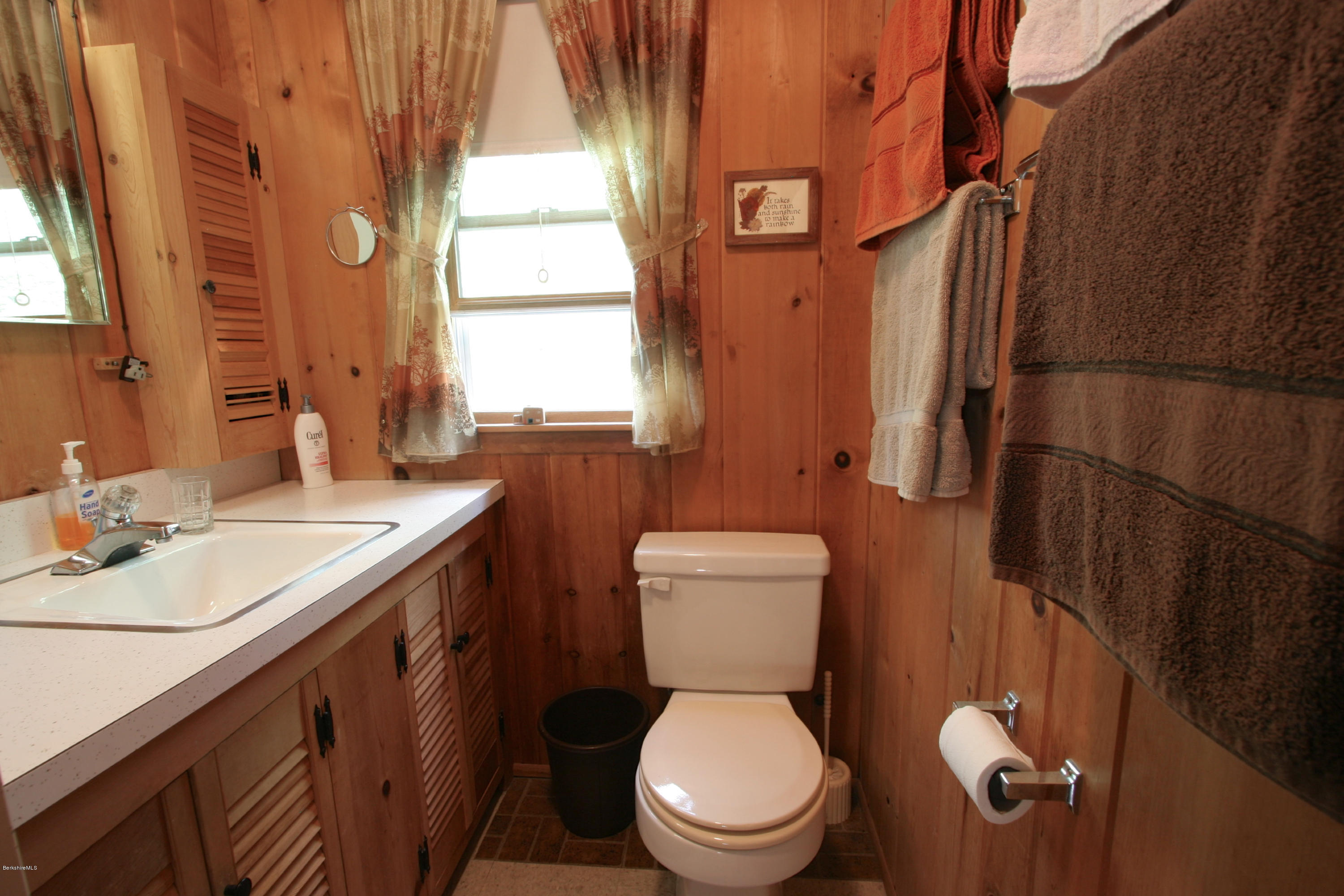 22 Housatonnuck Road Stockbridge, MA 01262 - Photo 15 of 21 a white toilet sitting next to a bathroom sink