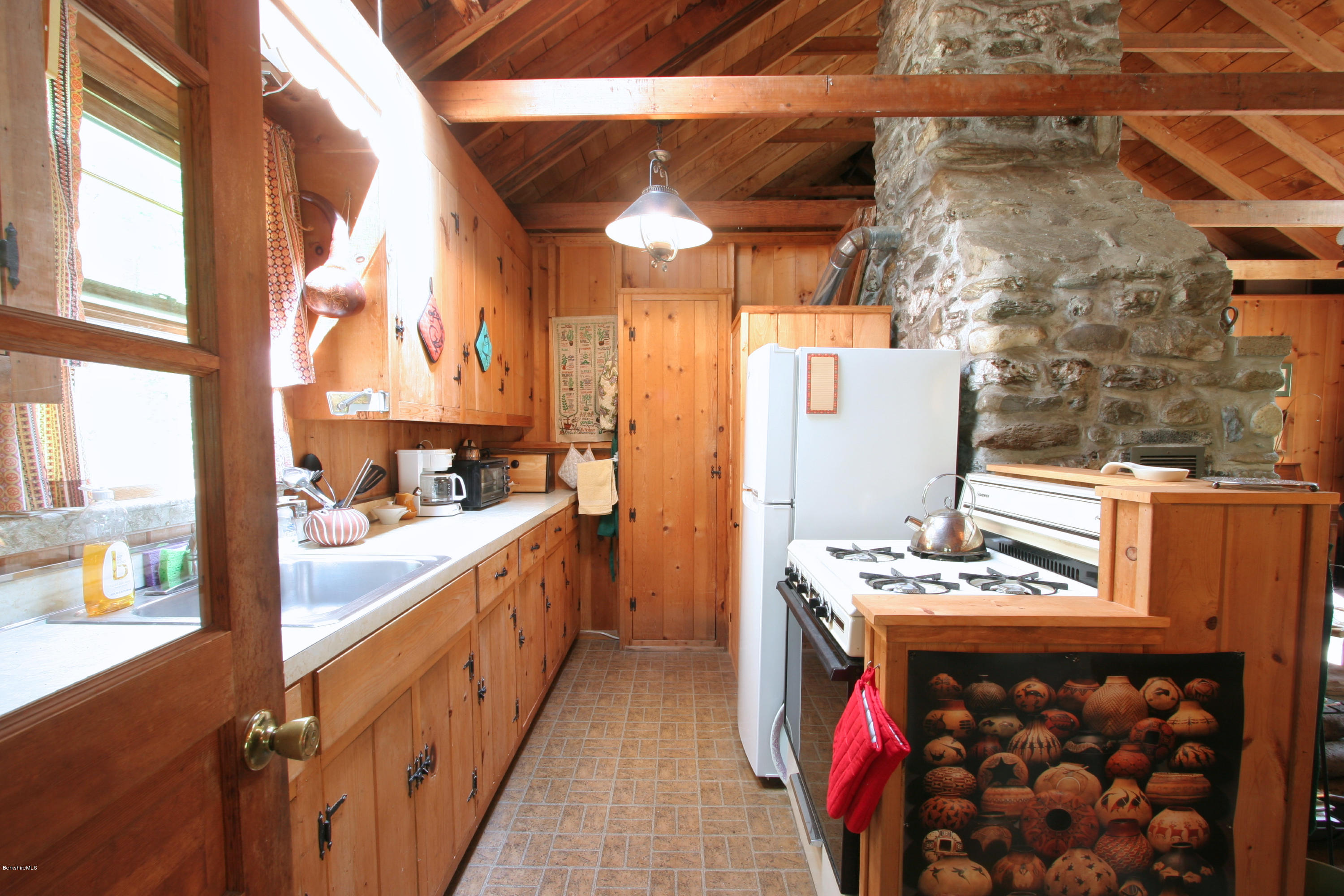 22 Housatonnuck Road Stockbridge, MA 01262 - Photo 4 of 21 a kitchen with stainless steel appliances kitchen island granite countertop a stove a sink and a refrigerator