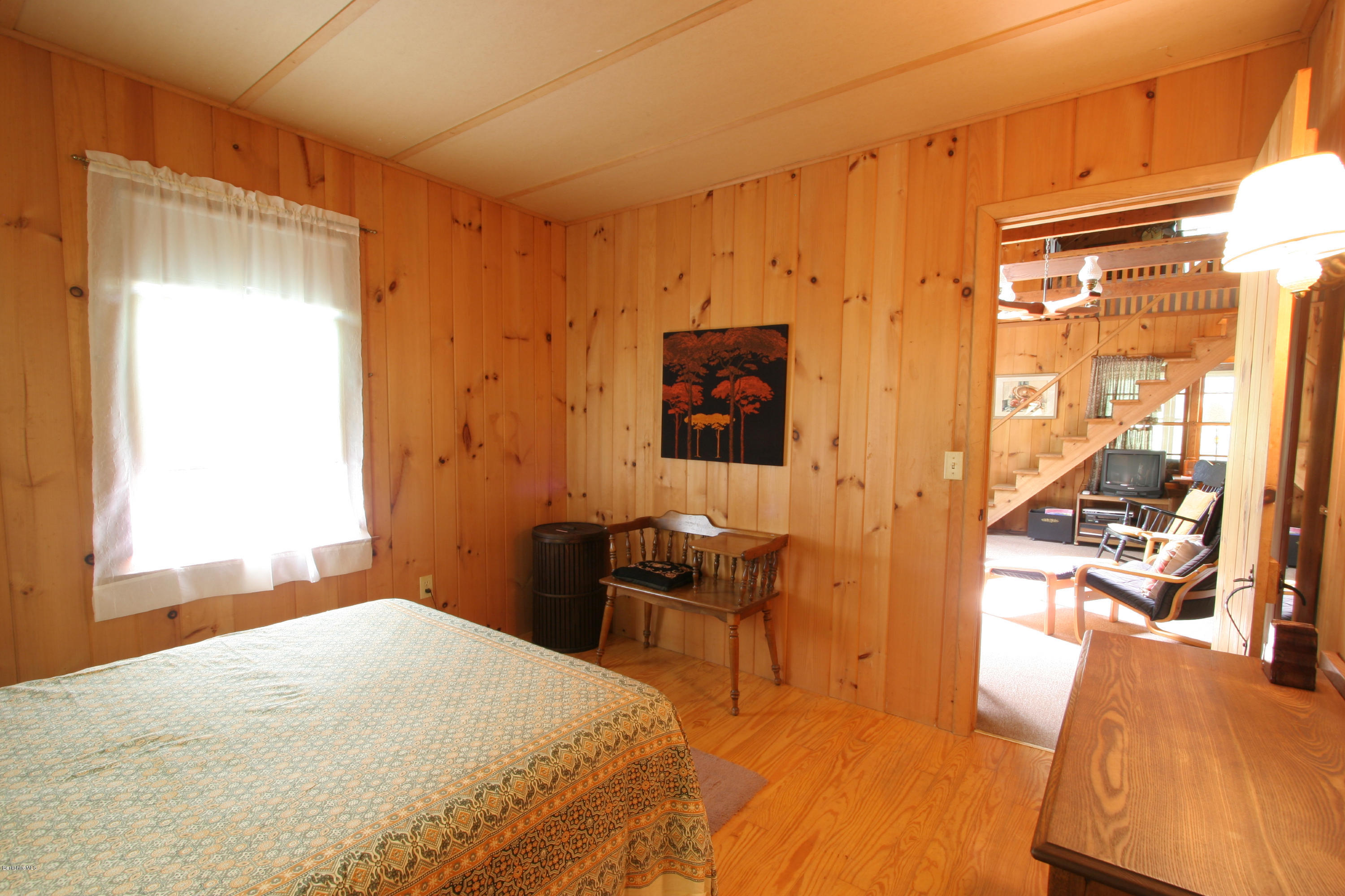 22 Housatonnuck Road Stockbridge, MA 01262 - Photo 5 of 21 a bedroom with a bed and wooden floor