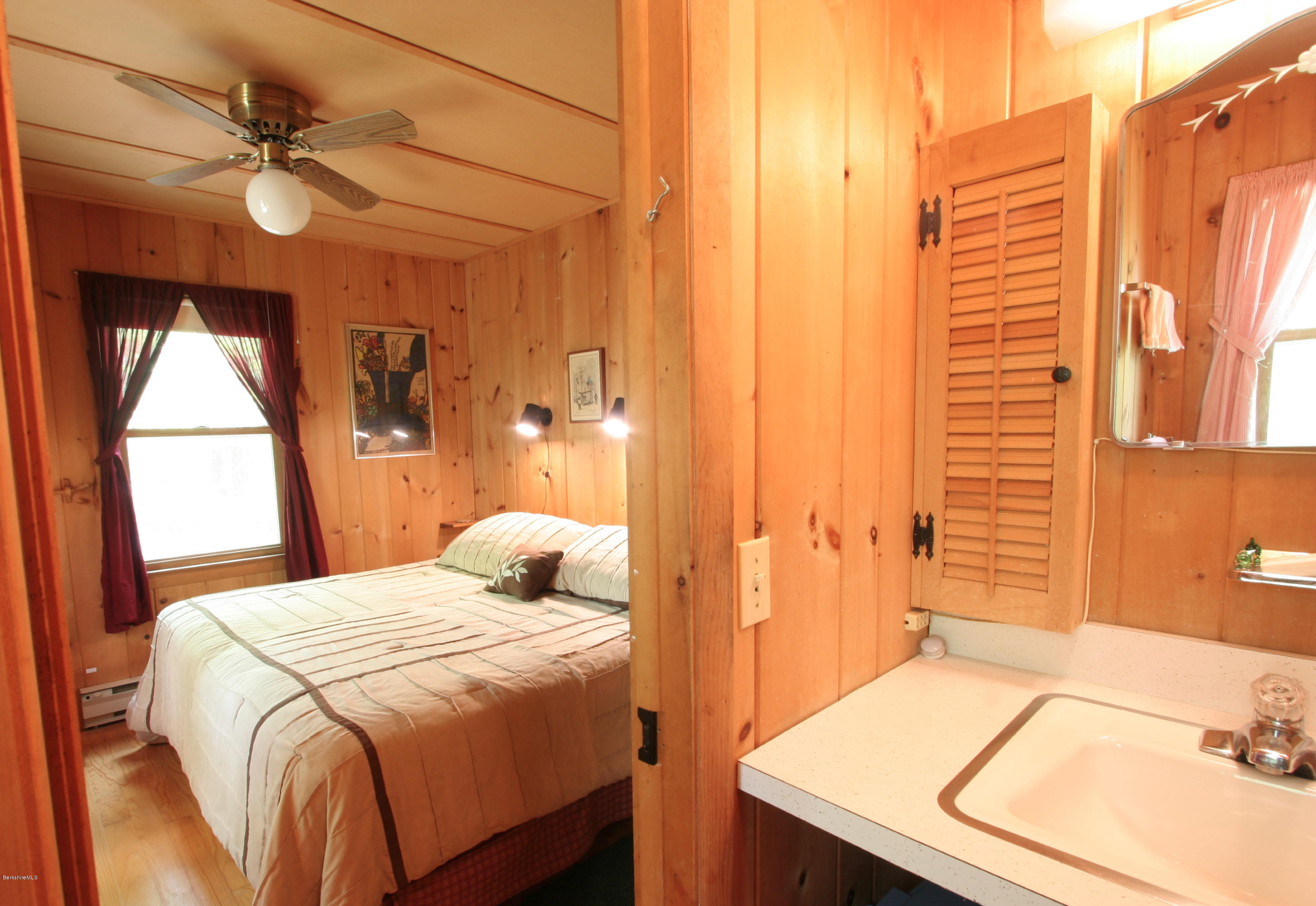22 Housatonnuck Road Stockbridge, MA 01262 - Photo 6 of 21 a bedroom with a bed and a table