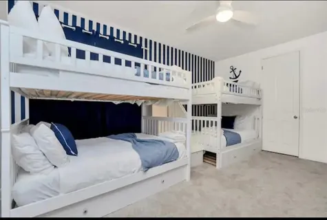 a swimming pool with outdoor seating and view of the house