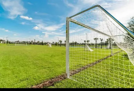 a view of a park with multi story residential houses