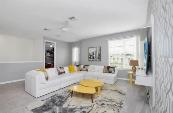 a living room with furniture and a chandelier