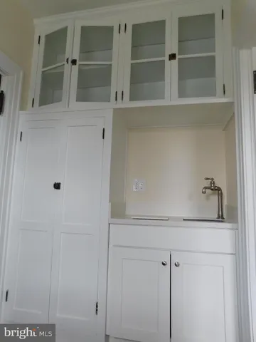 a bathroom with a sink and cabinets