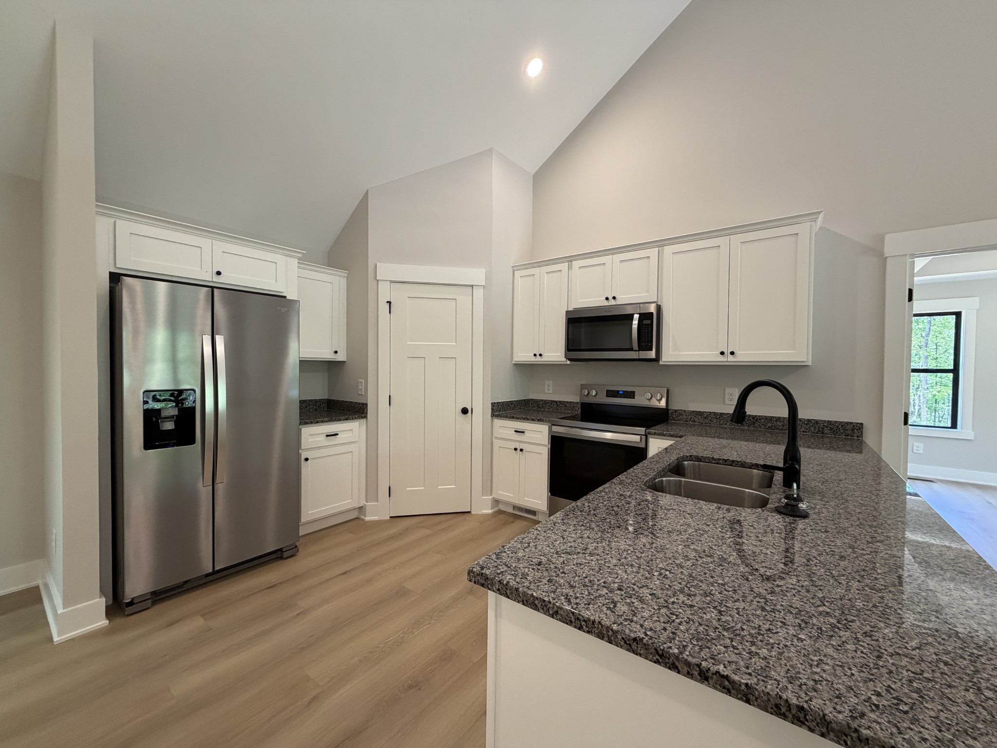 1007 Mt Olive Road Westmoreland, TN 37186 - Photo 15 of 31 a kitchen with stainless steel appliances granite countertop a sink stove and refrigerator