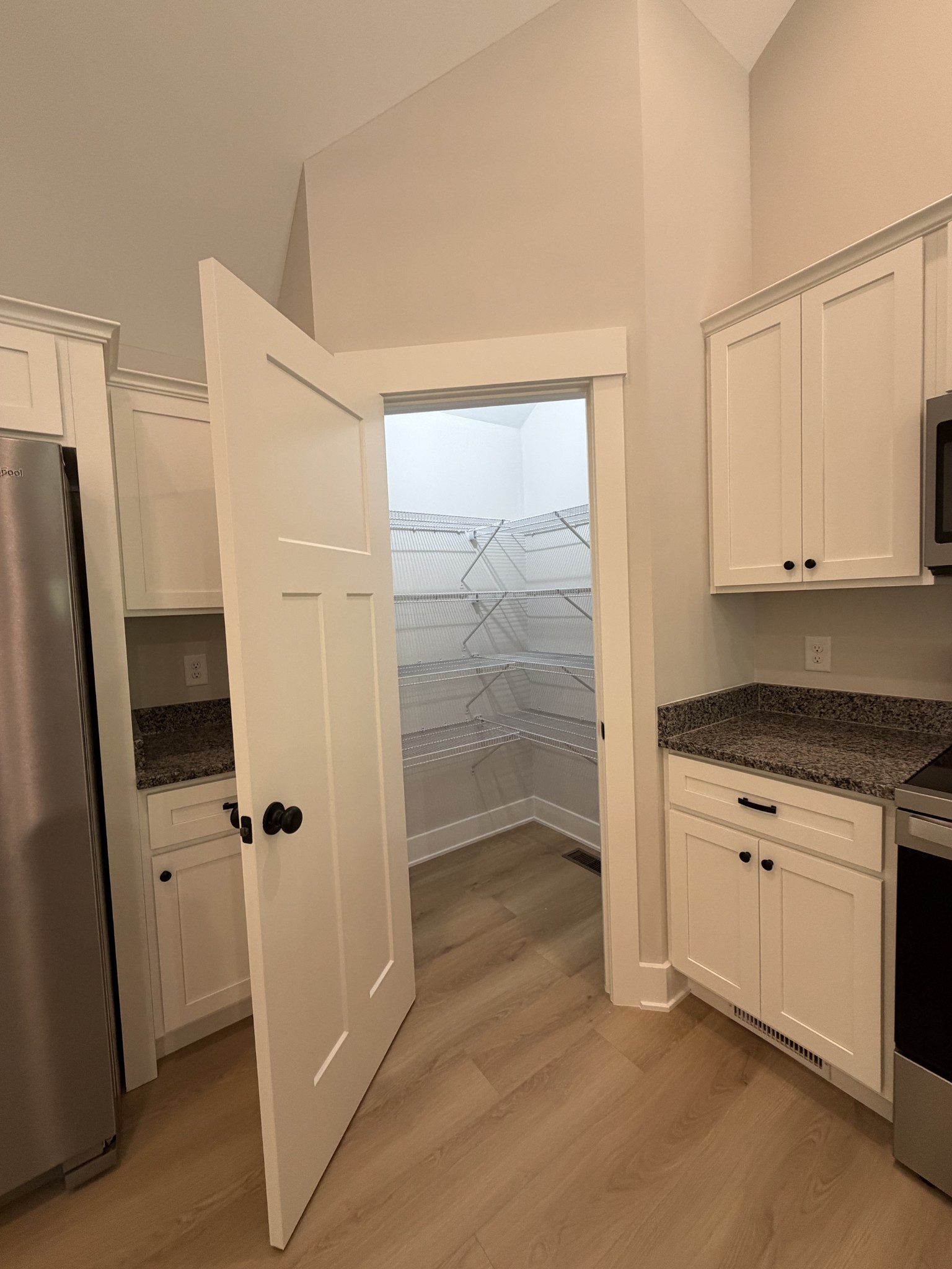 1007 Mt Olive Road Westmoreland, TN 37186 - Photo 16 of 31 a view of cabinets with stainless steel appliances wooden floor and cabinet