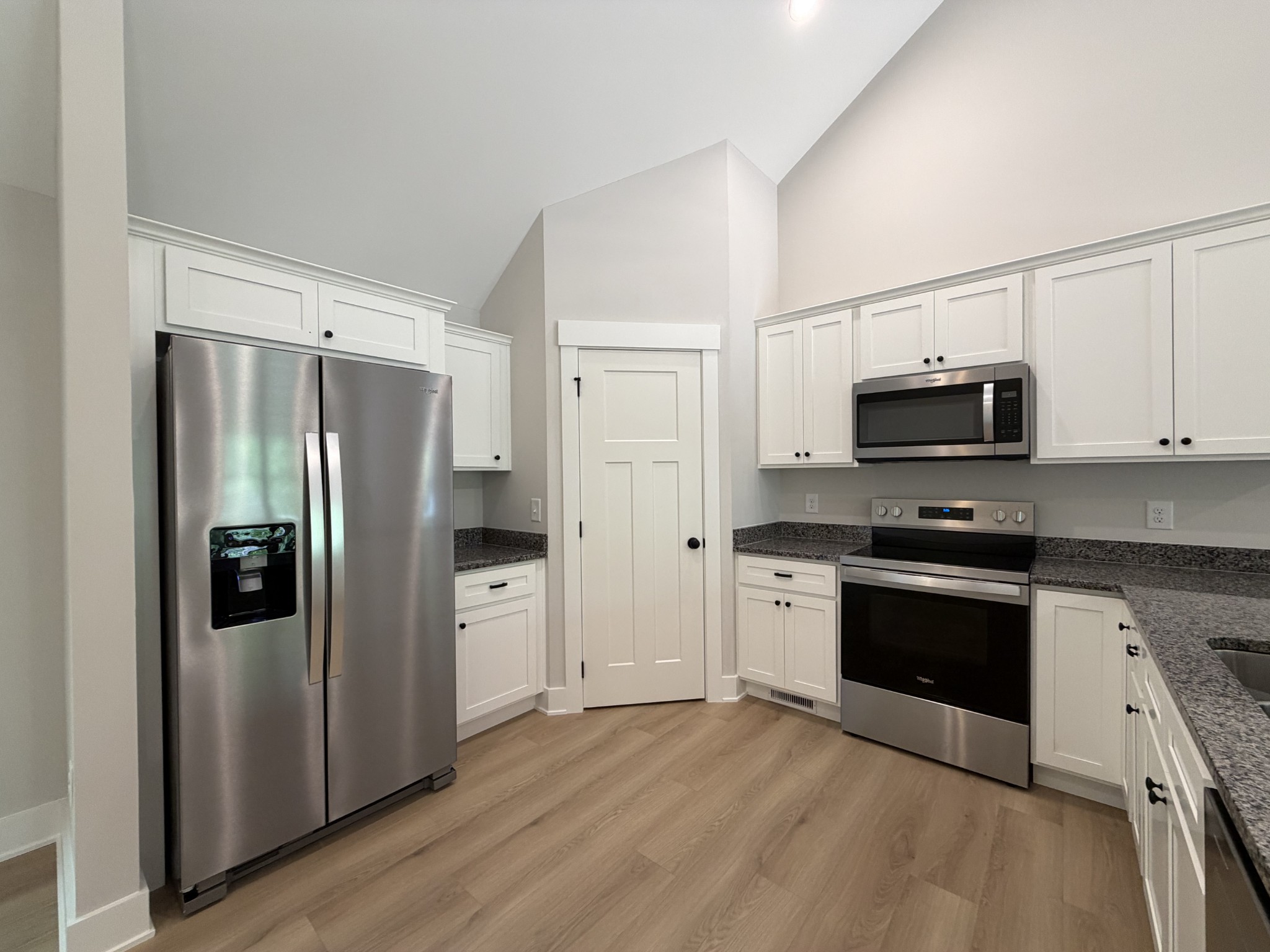 1007 Mt Olive Road Westmoreland, TN 37186 - Photo 17 of 31 a kitchen with stainless steel appliances granite countertop a refrigerator stove and sink