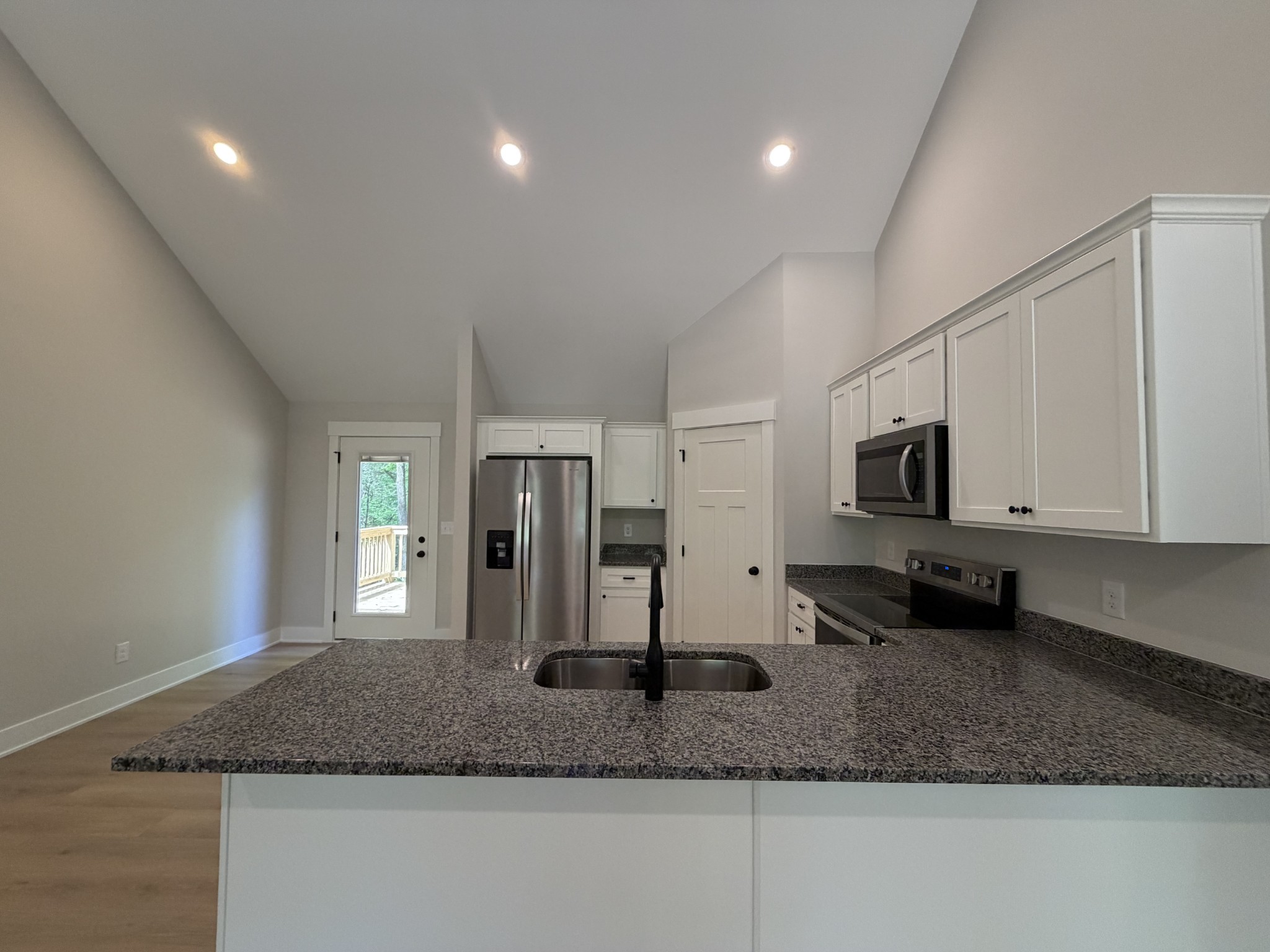 1007 Mt Olive Road Westmoreland, TN 37186 - Photo 18 of 31 a kitchen with stainless steel appliances granite countertop a sink a granite counter tops and a white cabinets