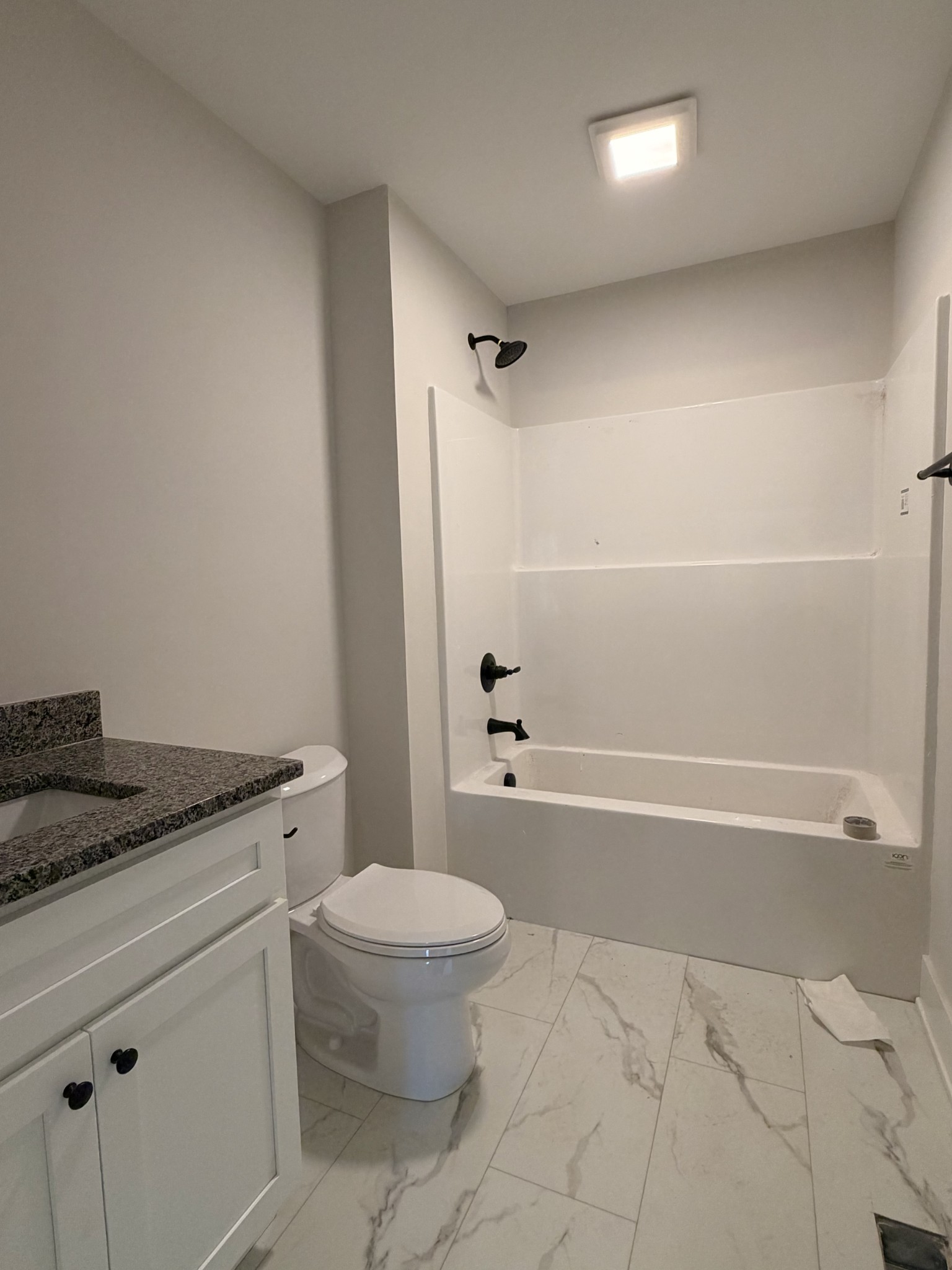 1007 Mt Olive Road Westmoreland, TN 37186 - Photo 20 of 31 a bathroom with a granite countertop toilet a sink and bathtub