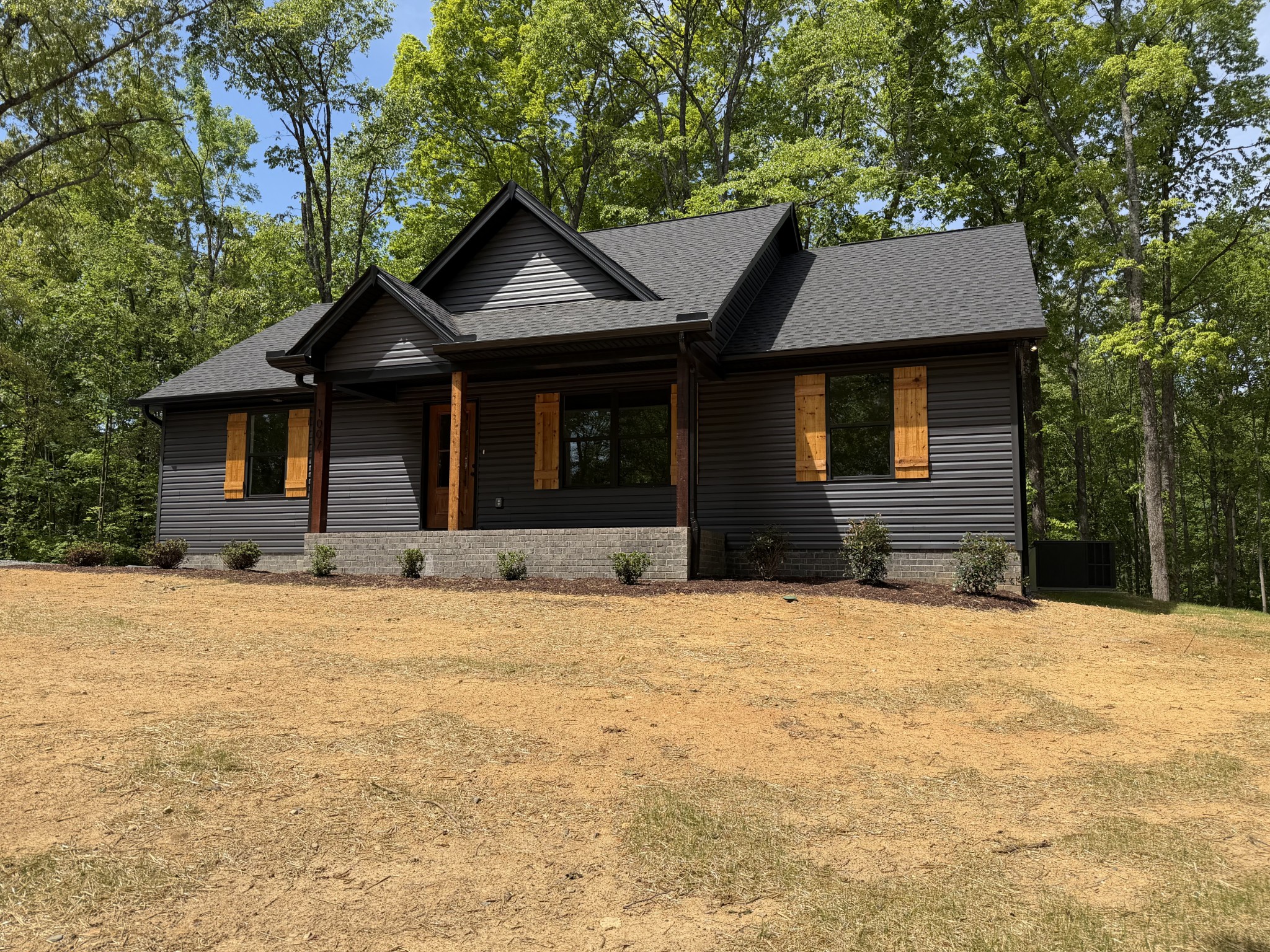 1007 Mt Olive Road Westmoreland, TN 37186 - Photo 2 of 31 a front view of a house with a yard and garage