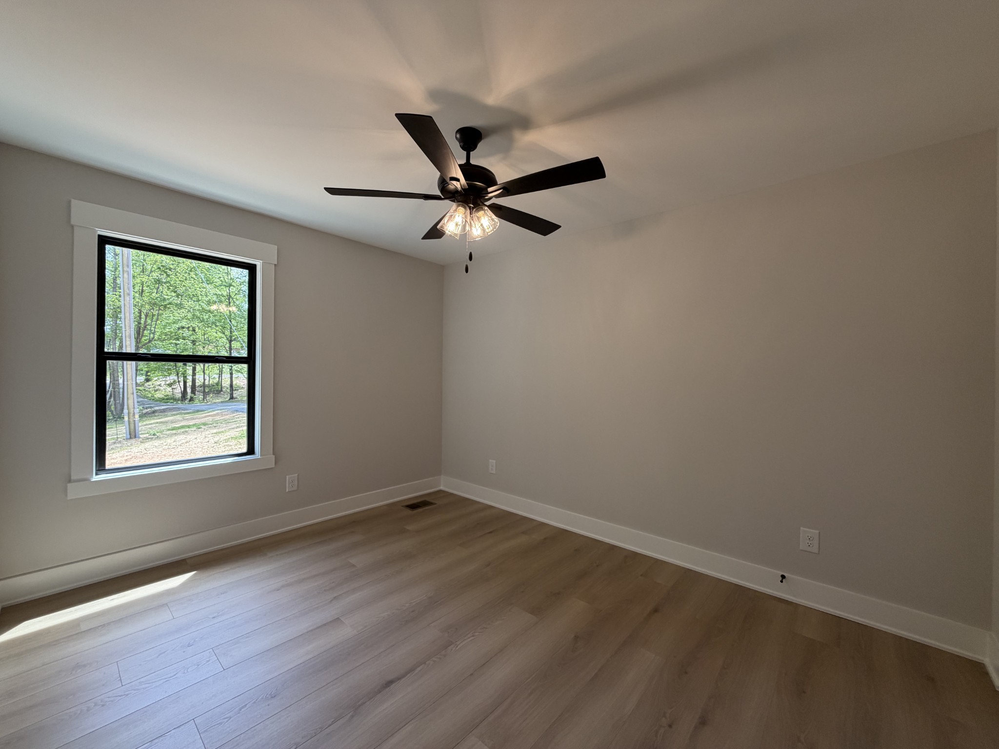 1007 Mt Olive Road Westmoreland, TN 37186 - Photo 24 of 31 an empty room with wooden floor fan and windows