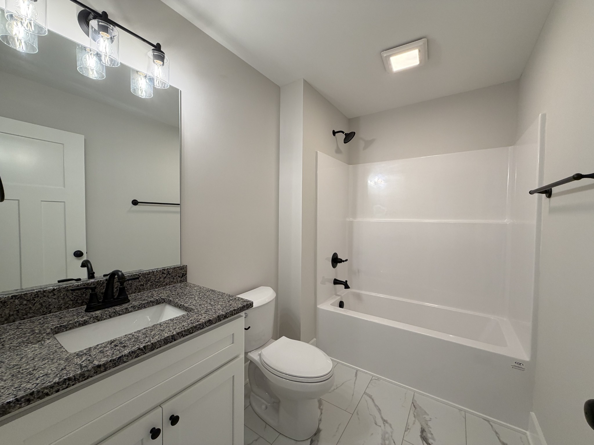 1007 Mt Olive Road Westmoreland, TN 37186 - Photo 25 of 31 a bathroom with a granite countertop sink a toilet and shower