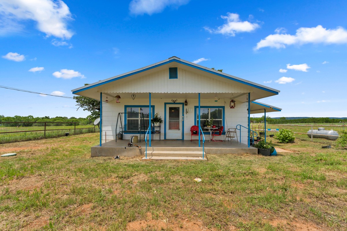 6311 Ranch Road 2241 Bluffton, TX 78607 - Photo 1 of 32 a view of a house with backyard porch and sitting area