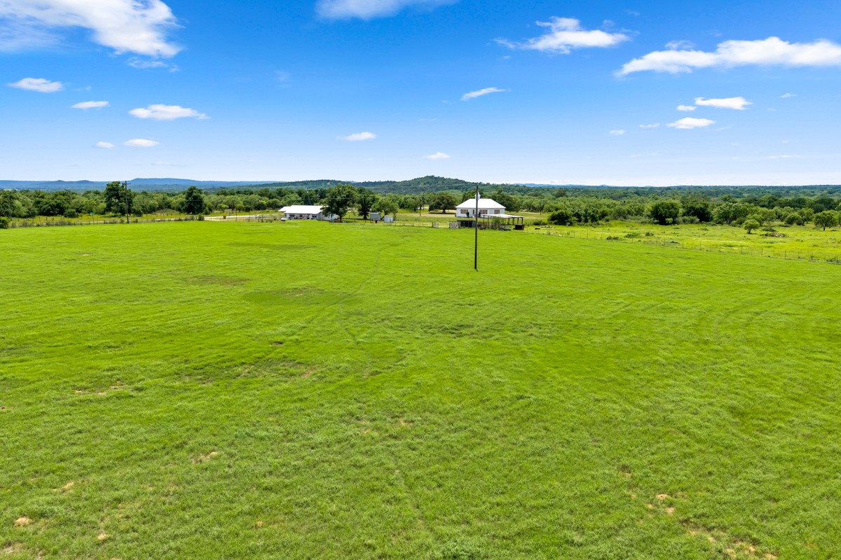 6311 Ranch Road 2241 Bluffton, TX 78607 - Photo 23 of 32 a view of a big yard with an trees in the background