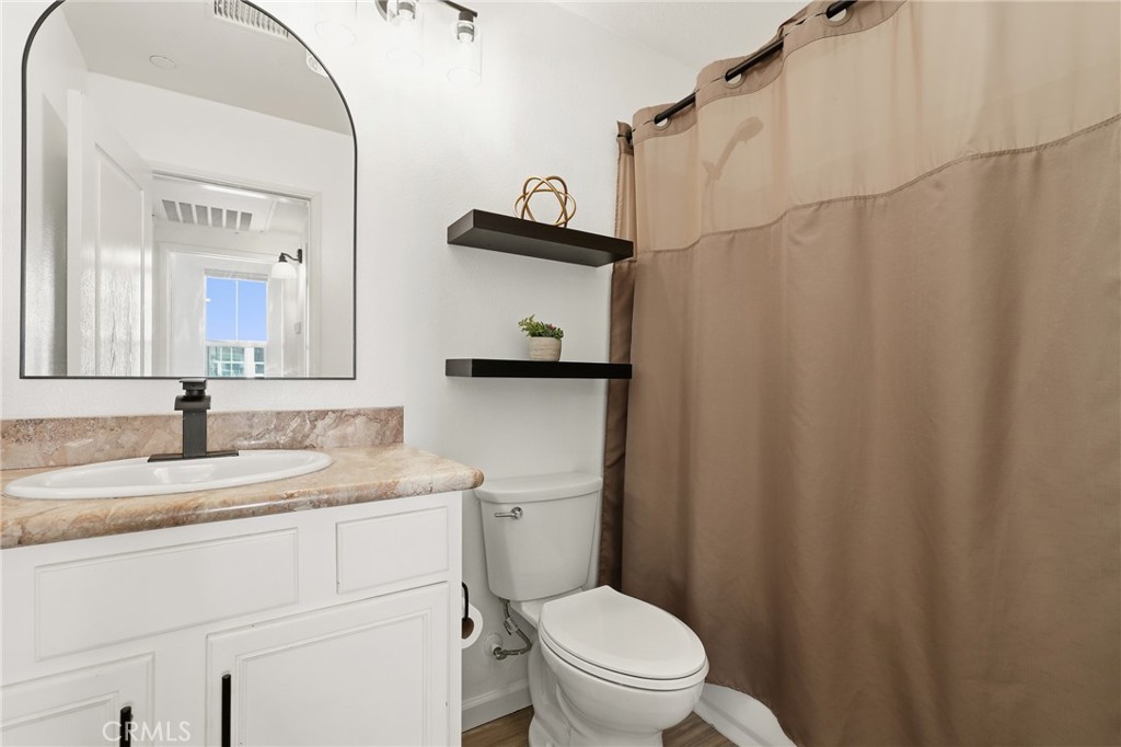 52 Valmont Way Ladera Ranch, CA 92694 - Photo 16 of 29 a bathroom with a granite countertop sink toilet and a mirror