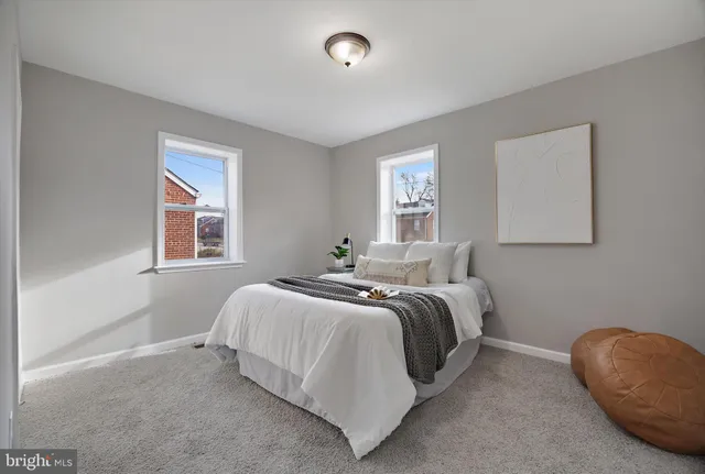 a spacious bedroom with a bed and a window