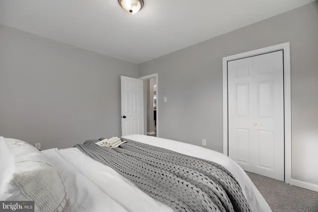 a bedroom with a bed and a mirror
