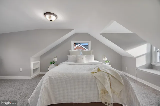 a bedroom with a bed and a lamp