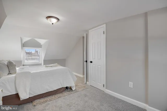 a bedroom with a bed and a night stand