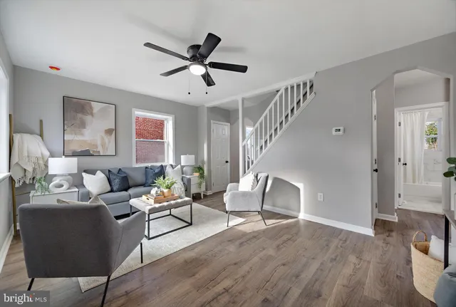 a living room with furniture and a wooden floor