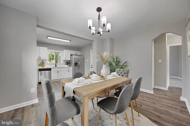 a view of a dining room with furniture wooden floor and chandelier