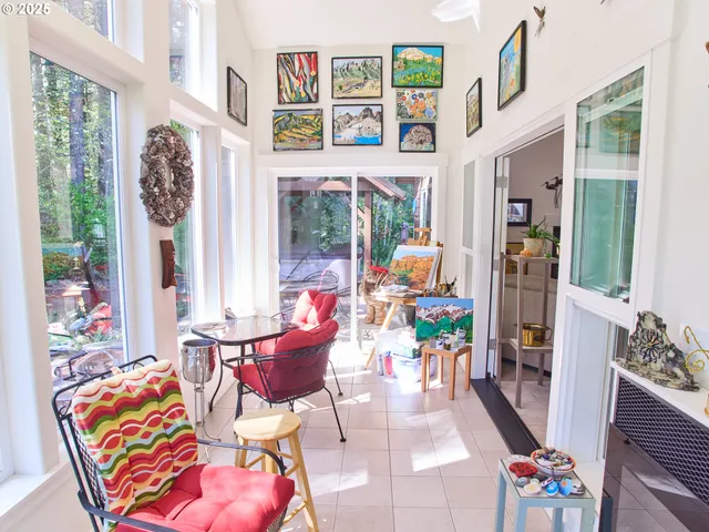 a living room with furniture and a floor to ceiling window
