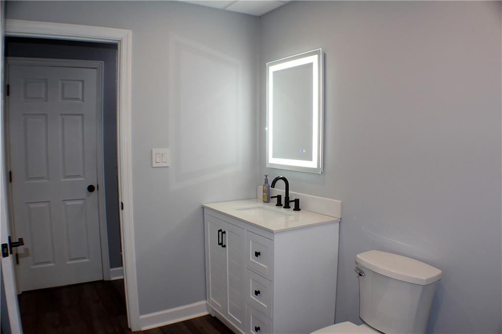9462 Peebles Road Allison Park, PA 15101 - Photo 18 of 50 a bathroom with a toilet a sink a vanity and mirror