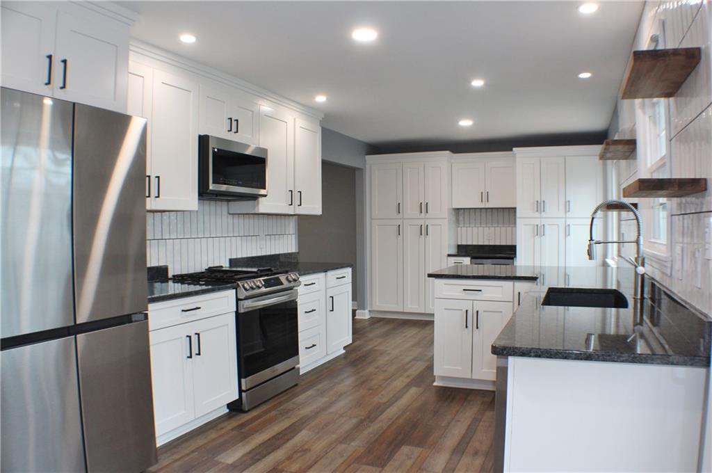 9462 Peebles Road Allison Park, PA 15101 - Photo 2 of 50 a kitchen with stainless steel appliances a stove a sink a refrigerator a microwave and cabinets